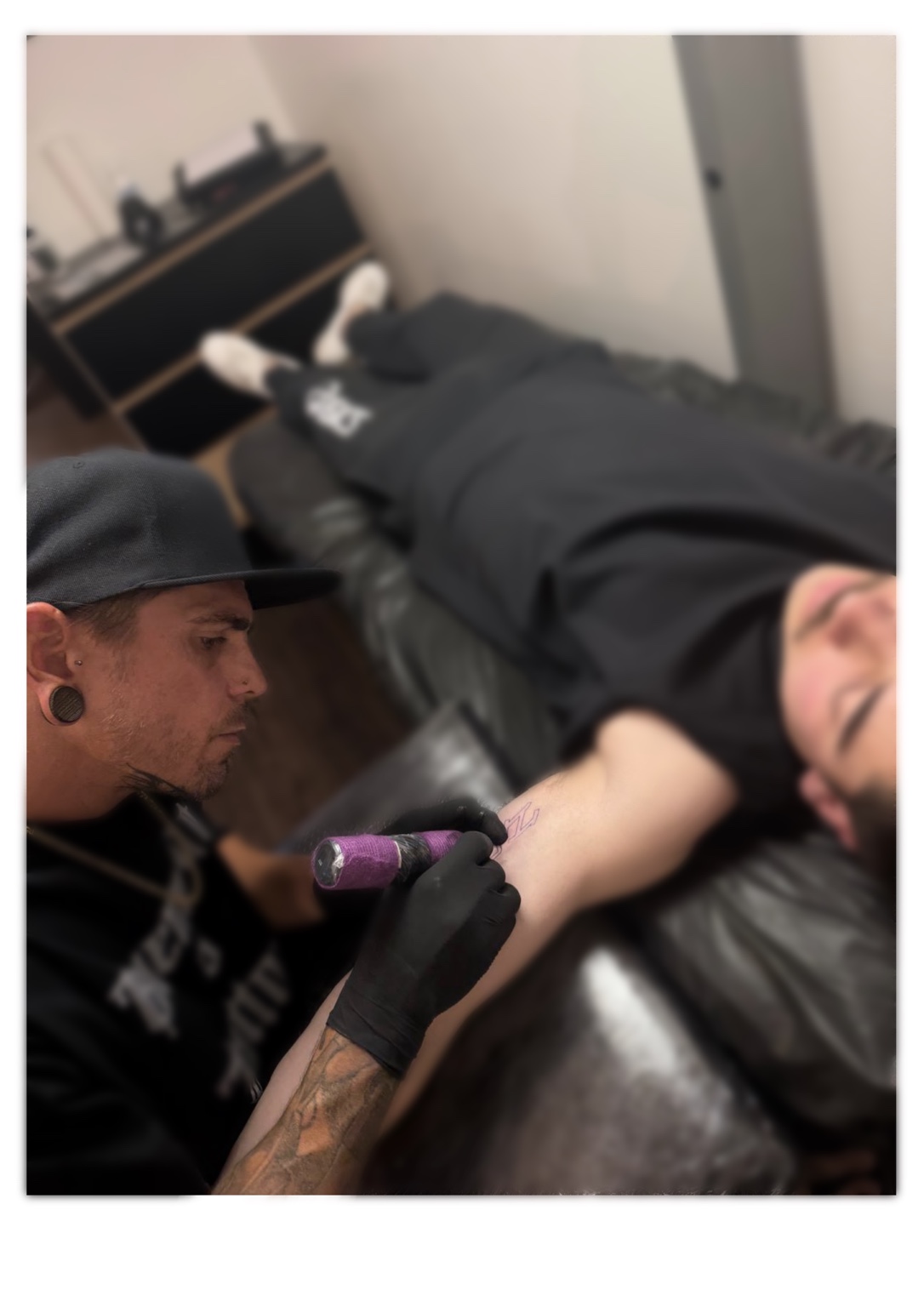 John Paul Curtis tattooing a client